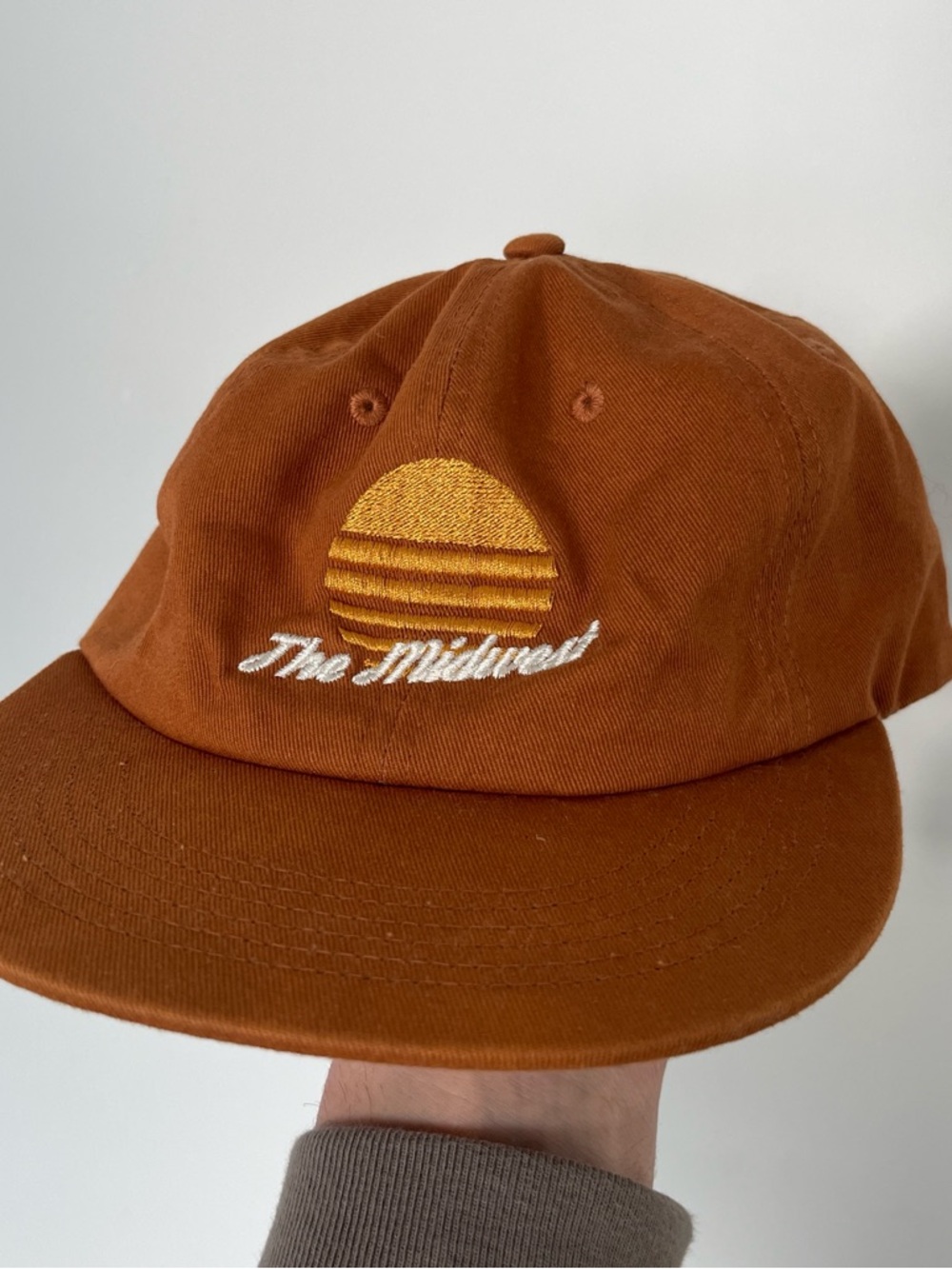 Rust Orange Embroidered Baseball Cap with Yellow Sun Logo